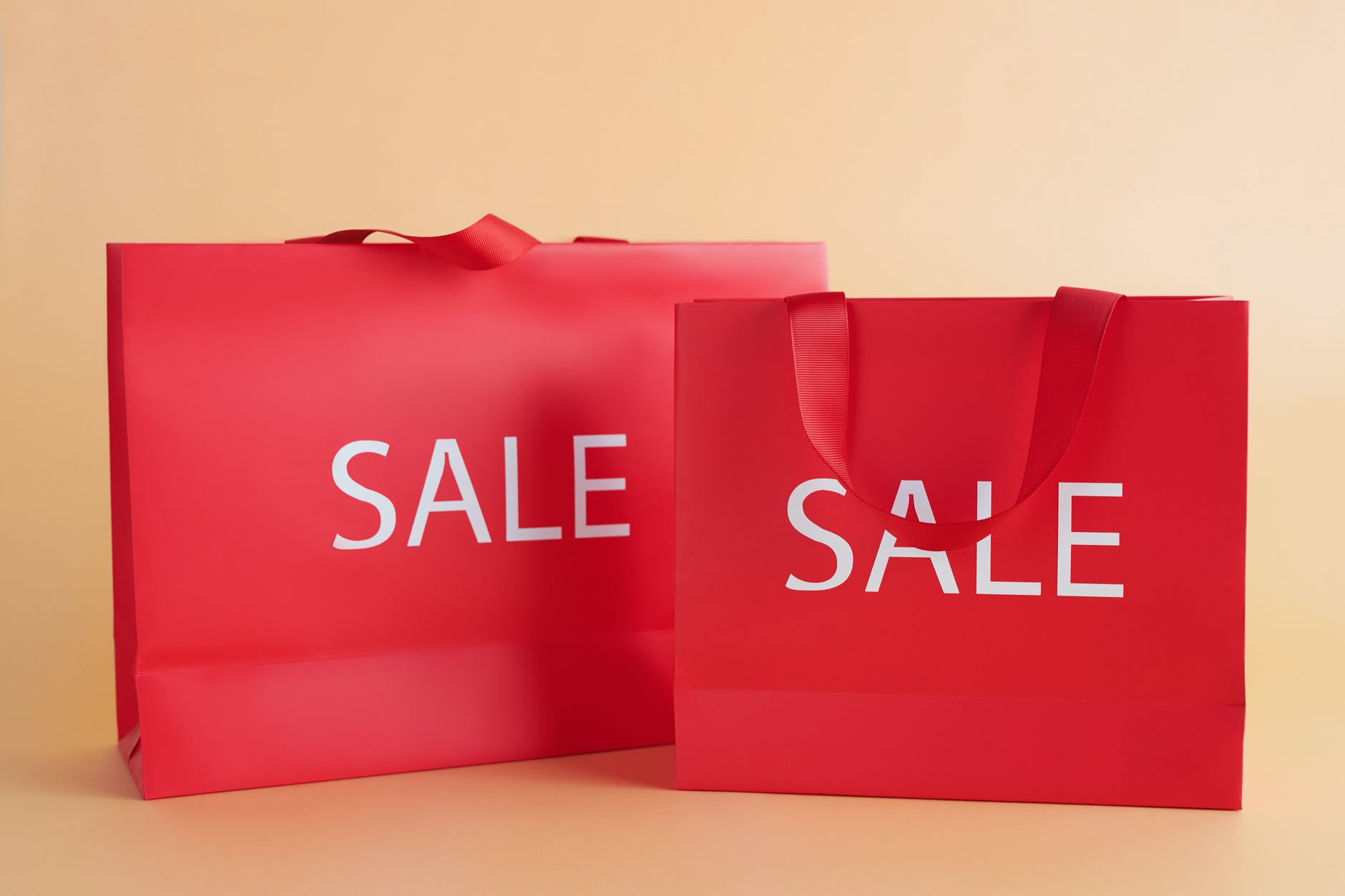red gift bags with sale sign