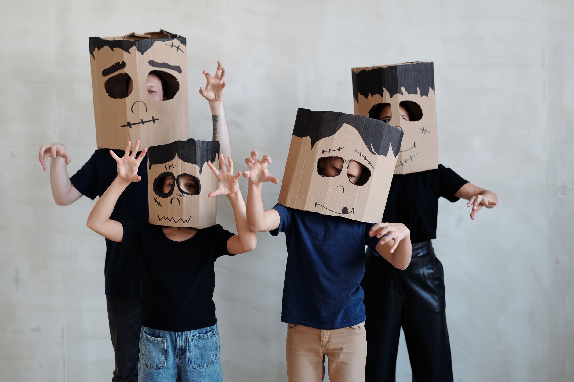 a family wearing a diy cardboard box mask