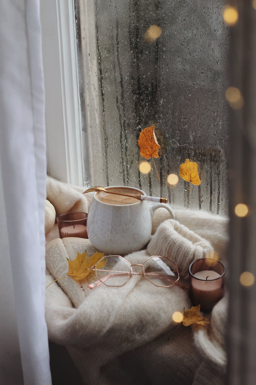 coffee glasses and sweater on book in autumn scene