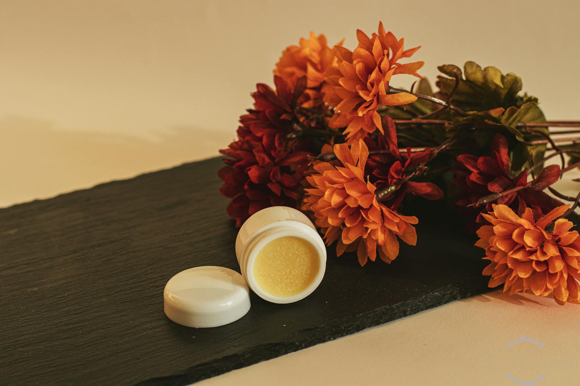 a peeling next to a bouquet of orange flowers