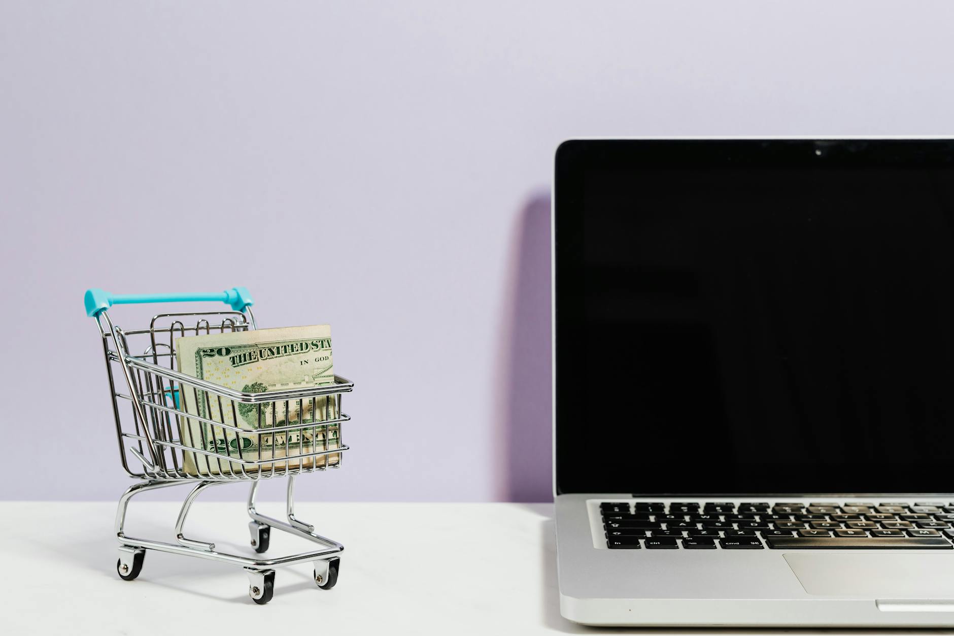 shopping cart next to a laptop