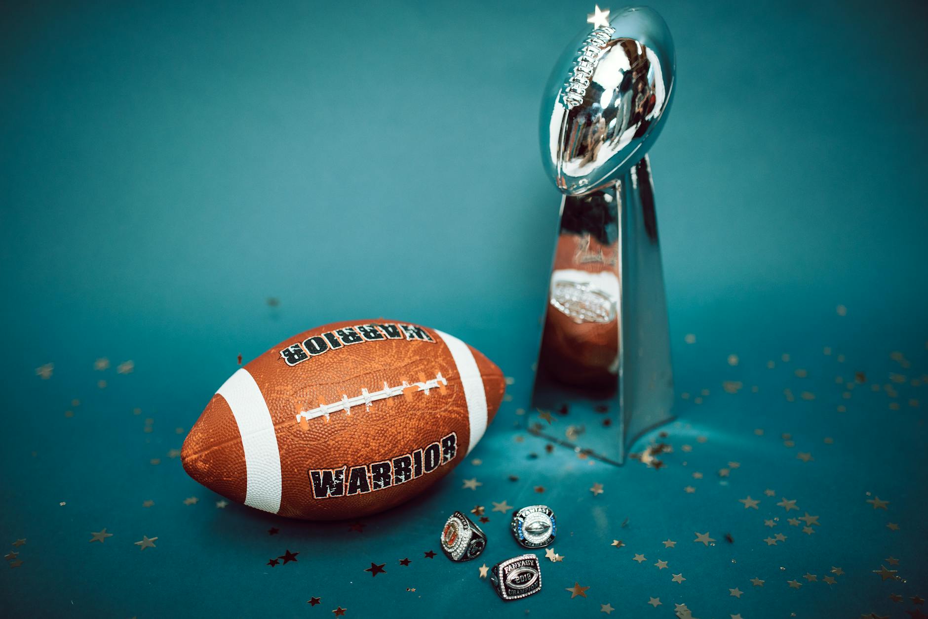 a football beside a vince lombardi trophy